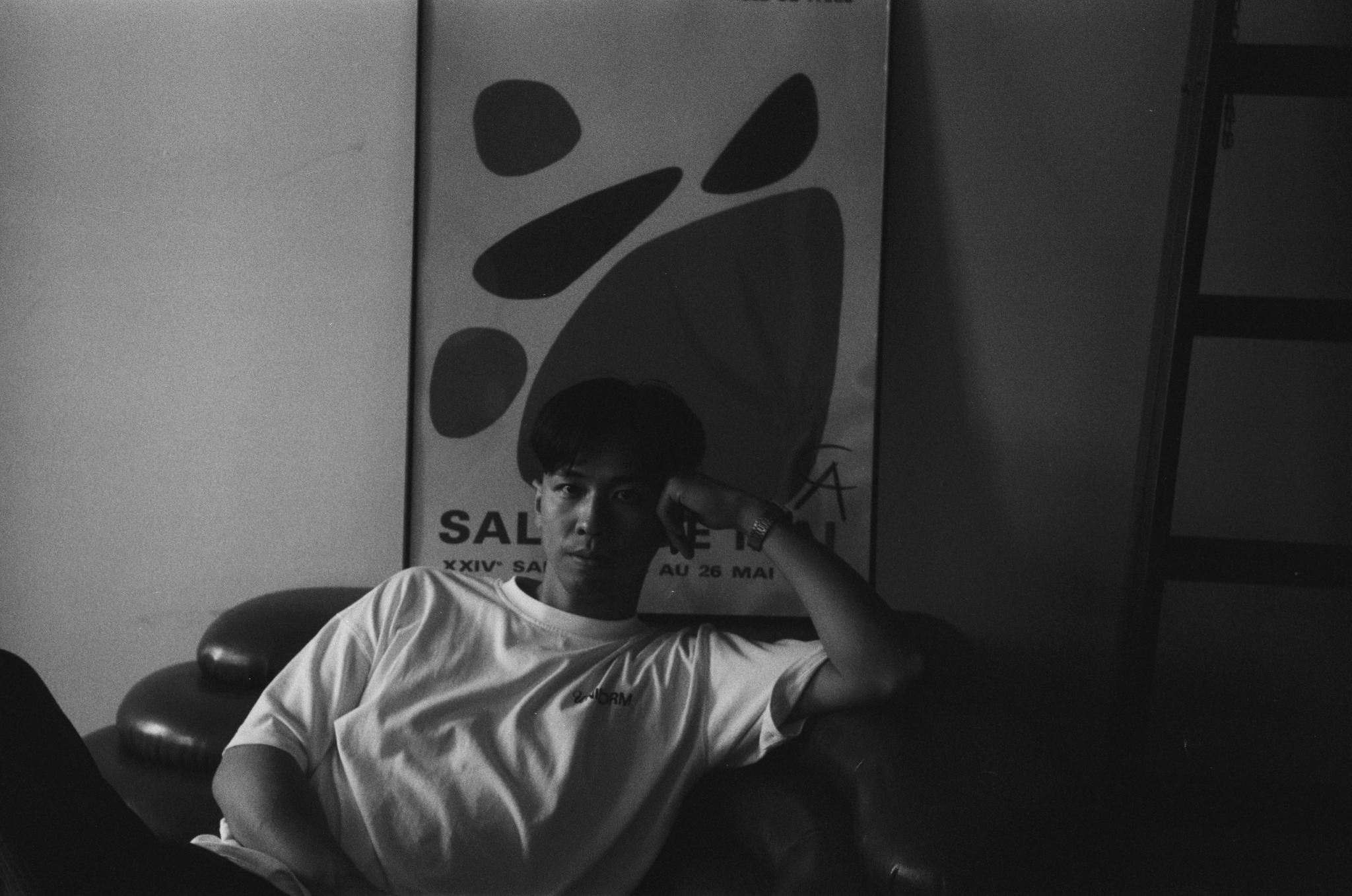 Black-and-white portrait of Nam Anh seated in an armchair